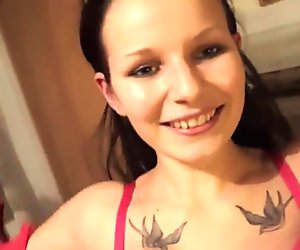 Kinky babe with a tattoo fingers her pussy